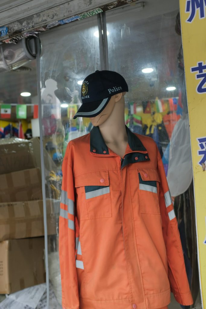 mannequin-wearing-an-orange-uniform-and-police-cap-hdhz0tehwpa