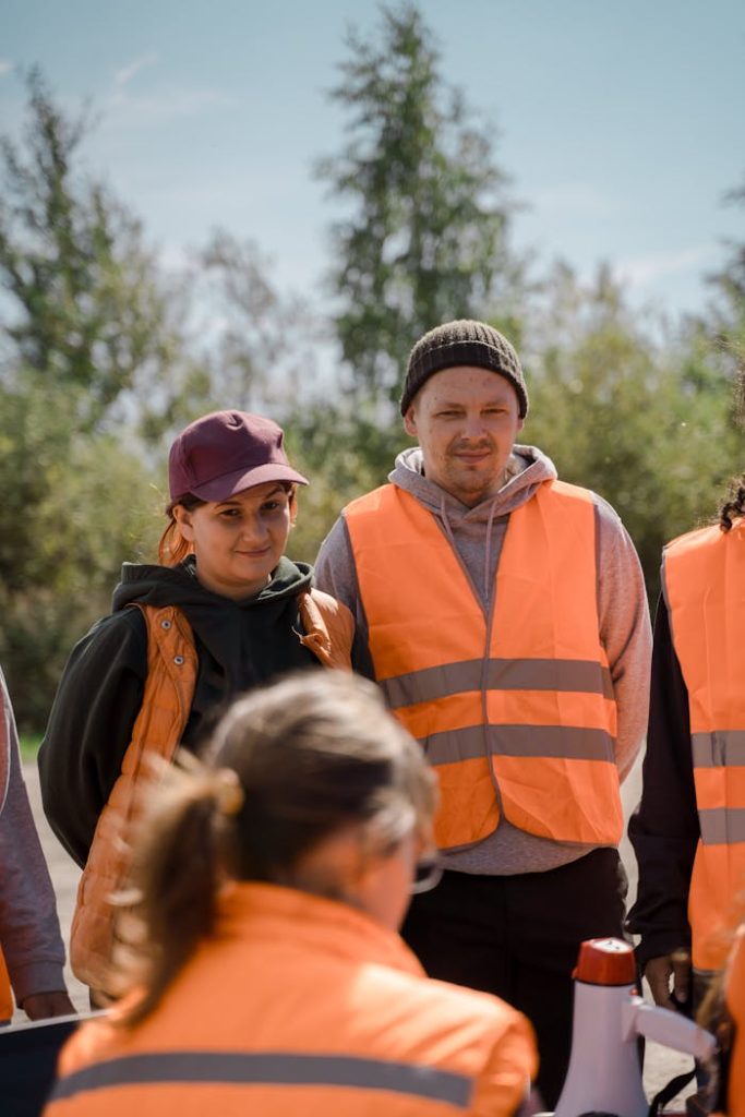 Group of people in high-vis vests working outdoors, showcasing teamwork.